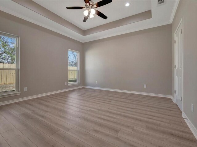 108 Saddle Brook Dr, Lufkin, TX 75904 - unfurnished room with a tray ceiling, healthy amount of natural light, light wood-style floors, and recessed lighting