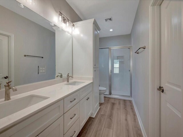 108 Saddle Brook Dr, Lufkin, TX 75904 - full bath with wood finished floors, double vanity, a shower stall, and recessed lighting