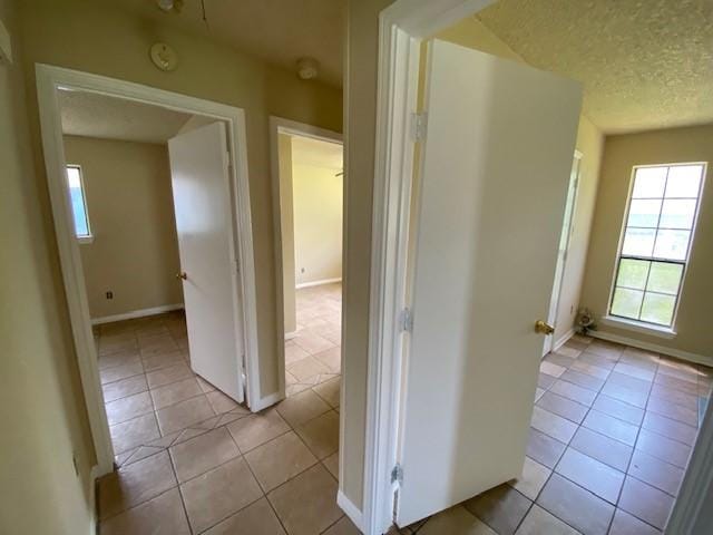 126 Oak St, Lancaster, TX 75146 - corridor featuring tile patterned floors and a textured ceiling