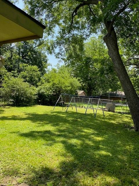 126 Oak St, Lancaster, TX 75146 - fenced backyard with a playground