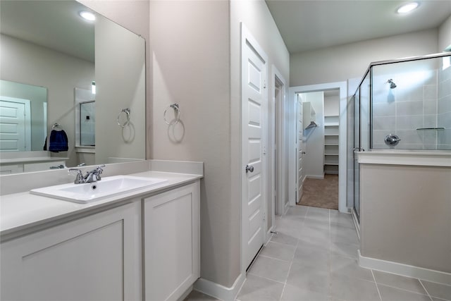 2208 Wexford Way, Forney, TX 75126 - bathroom featuring a stall shower, vanity, tile patterned floors, a walk in closet, and recessed lighting