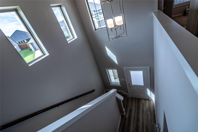 2208 Wexford Way, Forney, TX 75126 - stairway featuring a chandelier, wood finished floors, healthy amount of natural light, and a high ceiling
