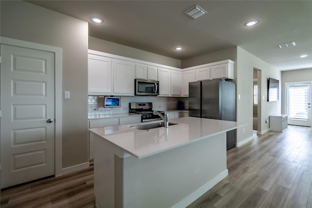 2208 Wexford Way, Forney, TX 75126 - kitchen featuring appliances with stainless steel finishes, white cabinets, light wood-type flooring, light countertops, and recessed lighting