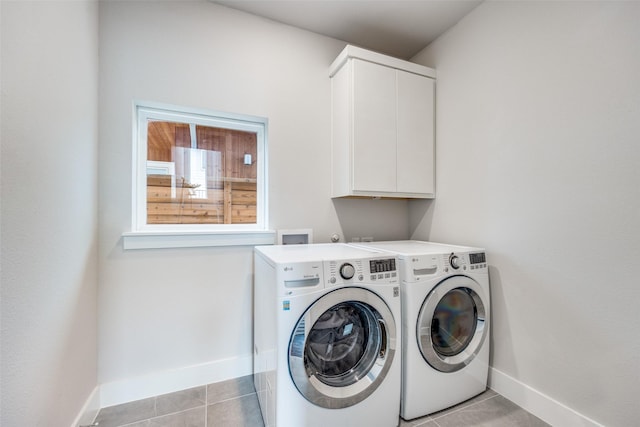 1022 Barsotti Ct, Dallas, TX 75212 - laundry room with cabinet space, washer and dryer, and light tile patterned floors