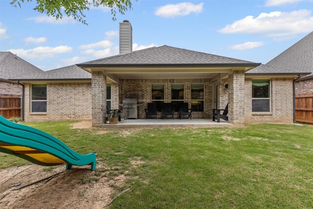 301 Prairie Oak Ct, Burleson, TX 76028 - rear view of house featuring brick siding, a patio area, a shingled roof, and a chimney