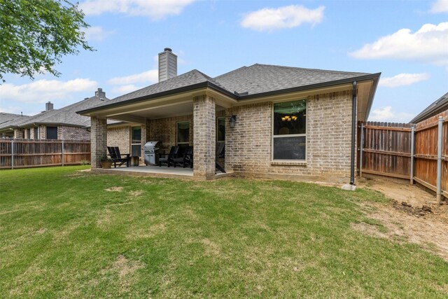 301 Prairie Oak Ct, Burleson, TX 76028 - back of house with a fenced backyard, a patio, brick siding, a chimney, and roof with shingles