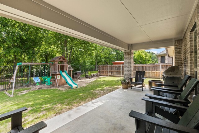 301 Prairie Oak Ct, Burleson, TX 76028 - fenced backyard featuring a playground, a patio area, and grilling area