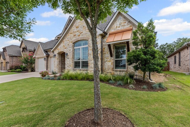 301 Prairie Oak Ct, Burleson, TX 76028 - french country home featuring stone siding, concrete driveway, a front yard, and a garage