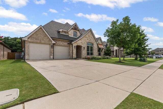 301 Prairie Oak Ct, Burleson, TX 76028 - french provincial home with a garage, brick siding, driveway, a shingled roof, and stone siding
