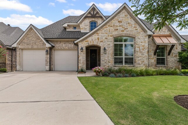 301 Prairie Oak Ct, Burleson, TX 76028 - french country inspired facade featuring stone siding, an attached garage, driveway, a front yard, and roof with shingles