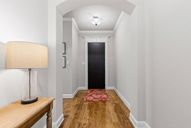 301 Prairie Oak Ct, Burleson, TX 76028 - doorway to outside featuring arched walkways, wood finished floors, and crown molding