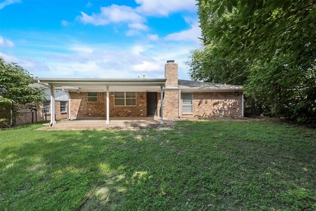 5504 Whitman Ave, Fort Worth, TX 76133 - back of property with a patio area, a chimney, and brick siding