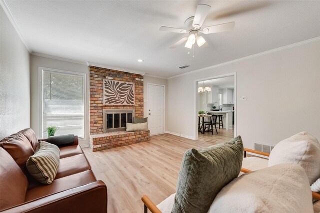 5504 Whitman Ave, Fort Worth, TX 76133 - living room with wood finished floors, ornamental molding, a ceiling fan, a chandelier, and a fireplace