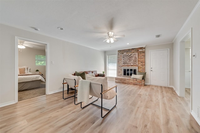 5504 Whitman Ave, Fort Worth, TX 76133 - living area with ornamental molding, ceiling fan, plenty of natural light, and light wood-style floors