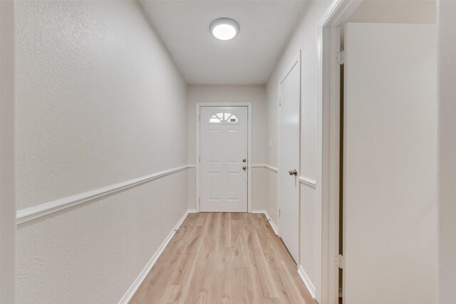 5504 Whitman Ave, Fort Worth, TX 76133 - doorway to outside with light wood-style floors and a textured wall