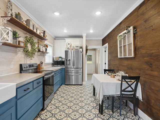 309 E 3rd St, Maypearl, TX 76064 - kitchen featuring stainless steel appliances, blue cabinetry, crown molding, open shelves, and light countertops