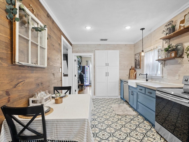 309 E 3rd St, Maypearl, TX 76064 - kitchen featuring stainless steel appliances, blue cabinets, wood walls, open shelves, and ornamental molding