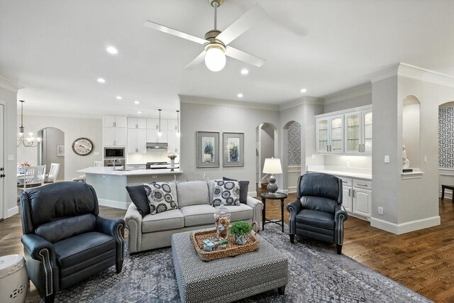 6617 Whittier Ln, Colleyville, TX 76034 - living room featuring arched walkways, ornamental molding, dark wood finished floors, a ceiling fan, and recessed lighting