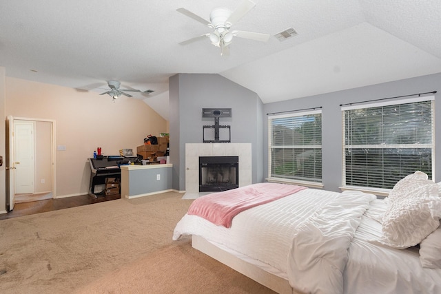 2120 Valley Falls Ave, Mesquite, TX 75181 - carpeted bedroom featuring vaulted ceiling, a ceiling fan, and a fireplace