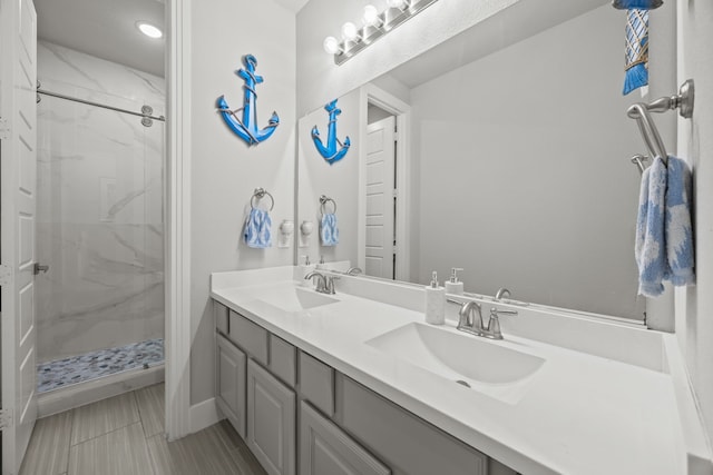 9424 Excursion Dr, Oak Point, TX 75068 - bathroom featuring double vanity and a marble finish shower