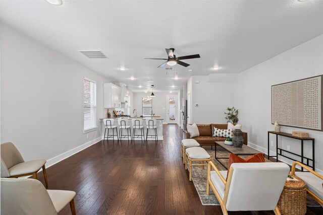 2905 Merrimac St, Fort Worth, TX 76107 - living area featuring ceiling fan and dark wood-style flooring