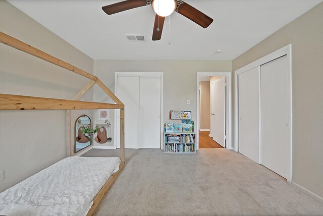 3767 Matson St, North Richland Hills, TX 76117 - carpeted bedroom featuring multiple closets and a ceiling fan