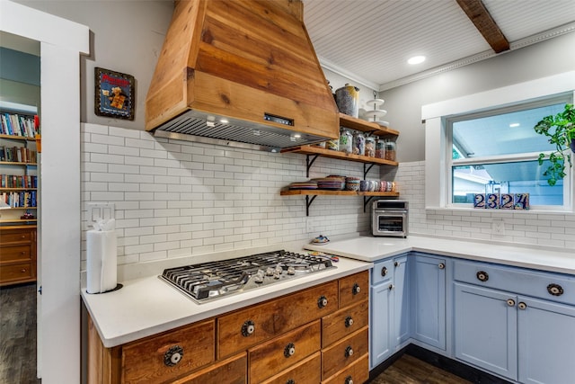 2324 Lynnhaven Rd, Fort Worth, TX 76103 - kitchen featuring stainless steel gas cooktop, dark wood-type flooring, island exhaust hood, light countertops, and ornamental molding