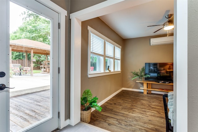 2324 Lynnhaven Rd, Fort Worth, TX 76103 - doorway featuring a ceiling fan, a wall mounted air conditioner, and wood finished floors