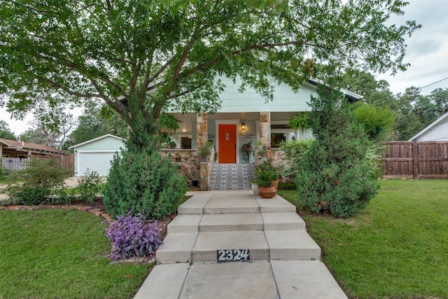 2324 Lynnhaven Rd, Fort Worth, TX 76103 - view of front of house with stone siding, a porch, and a garage