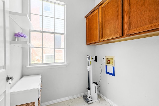 1092 Rosewood Dr, Grapevine, TX 76051 - laundry area featuring cabinet space, healthy amount of natural light, hookup for a washing machine, and light tile patterned flooring