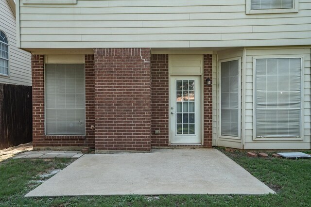1092 Rosewood Dr, Grapevine, TX 76051 - view of exterior entry with a patio area and brick siding