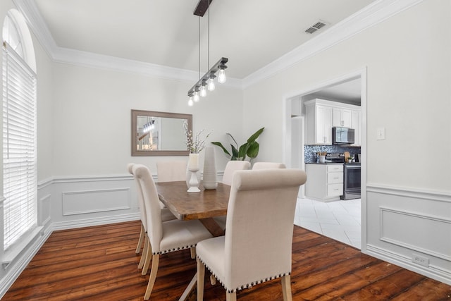1092 Rosewood Dr, Grapevine, TX 76051 - dining space with ornamental molding, wood finished floors, and wainscoting