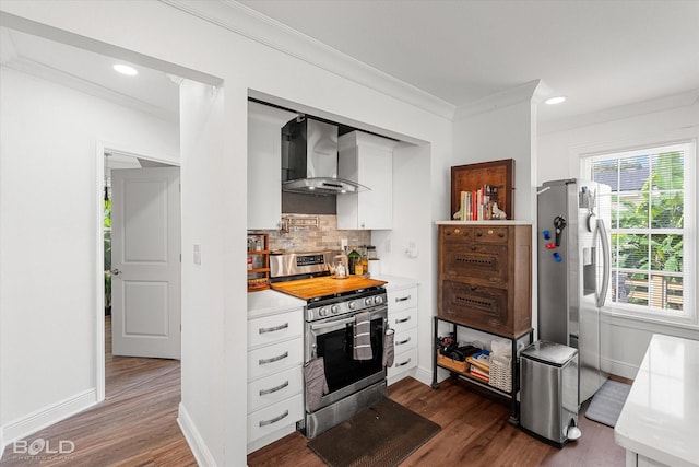 107 Preston Ave, Shreveport, LA 71105 - kitchen with wall chimney exhaust hood, stainless steel appliances, crown molding, white cabinets, and dark wood finished floors