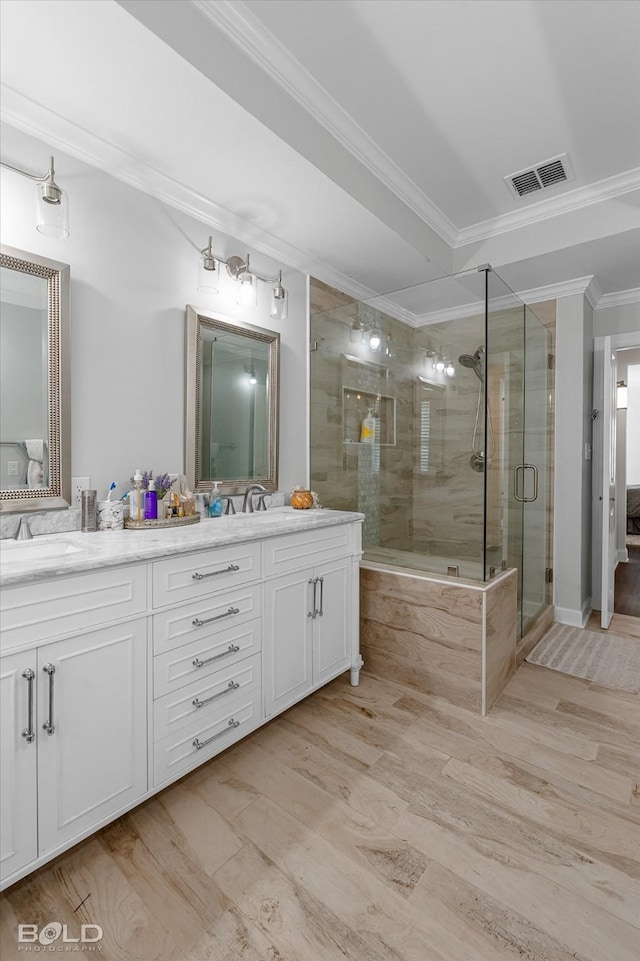 107 Preston Ave, Shreveport, LA 71105 - full bath featuring double vanity, a stall shower, wood finished floors, and crown molding