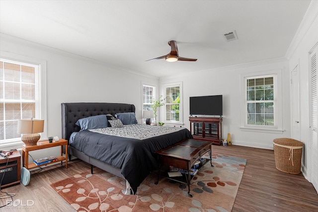 107 Preston Ave, Shreveport, LA 71105 - bedroom featuring multiple windows, wood finished floors, crown molding, and a ceiling fan