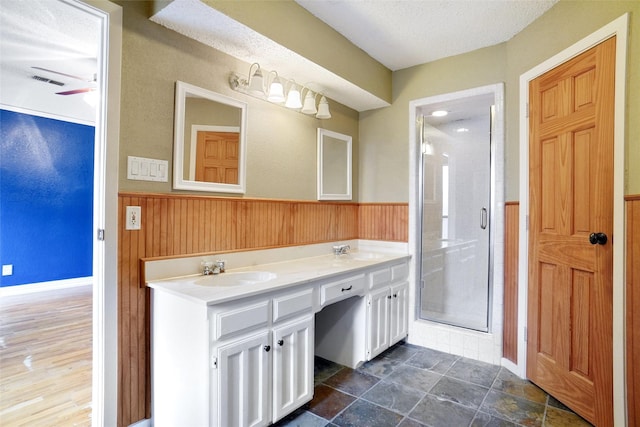 7440 Meadowview Ter, North Richland Hills, TX 76182 - full bath featuring a stall shower, a wainscoted wall, double vanity, a textured ceiling, and wood walls