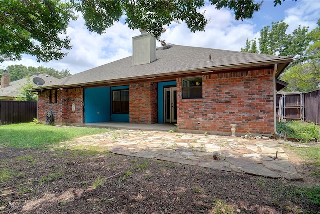 7440 Meadowview Ter, North Richland Hills, TX 76182 - rear view of house with a chimney, a patio area, brick siding, and roof with shingles