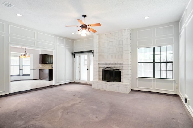 7440 Meadowview Ter, North Richland Hills, TX 76182 - unfurnished living room with carpet flooring, ceiling fan, a decorative wall, a brick fireplace, and recessed lighting