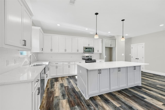 1807 Boxwood Dr, Sherman, TX 75092 - kitchen featuring appliances with stainless steel finishes, dark wood-style floors, white cabinets, and recessed lighting