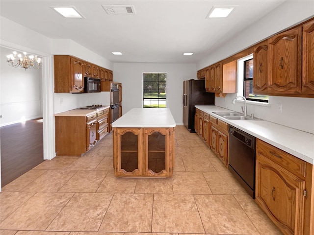 1846 Green Tree Ln, Duncanville, TX 75137 - kitchen featuring black appliances, a kitchen island, brown cabinetry, and light countertops