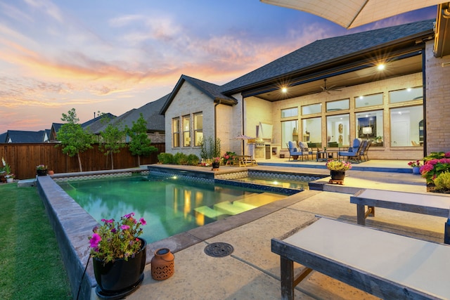 403 Trigger Trl, Argyle, TX 76226 - pool at dusk with a patio, a fenced backyard, and a pool with connected hot tub