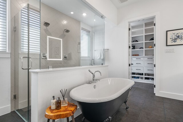 403 Trigger Trl, Argyle, TX 76226 - bathroom featuring a stall shower, a walk in closet, a freestanding bath, and tile patterned floors