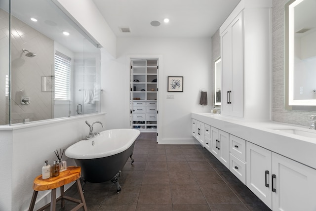 403 Trigger Trl, Argyle, TX 76226 - full bath featuring a stall shower, double vanity, a soaking tub, a walk in closet, and tile patterned flooring