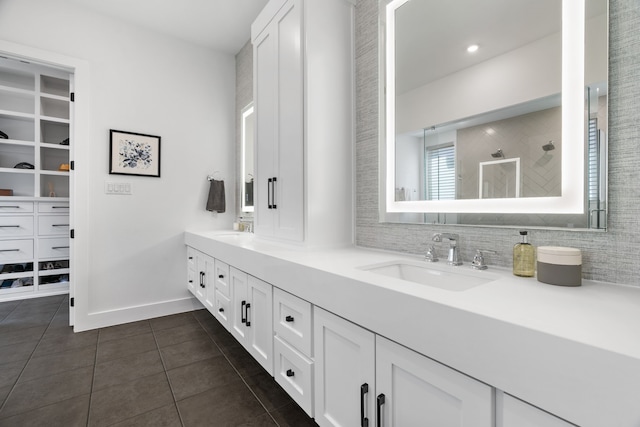 403 Trigger Trl, Argyle, TX 76226 - bathroom featuring double vanity, tile patterned floors, tiled shower, and a walk in closet