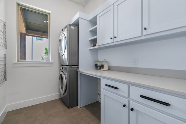 403 Trigger Trl, Argyle, TX 76226 - washroom with stacked washer / drying machine, cabinet space, and dark tile patterned flooring
