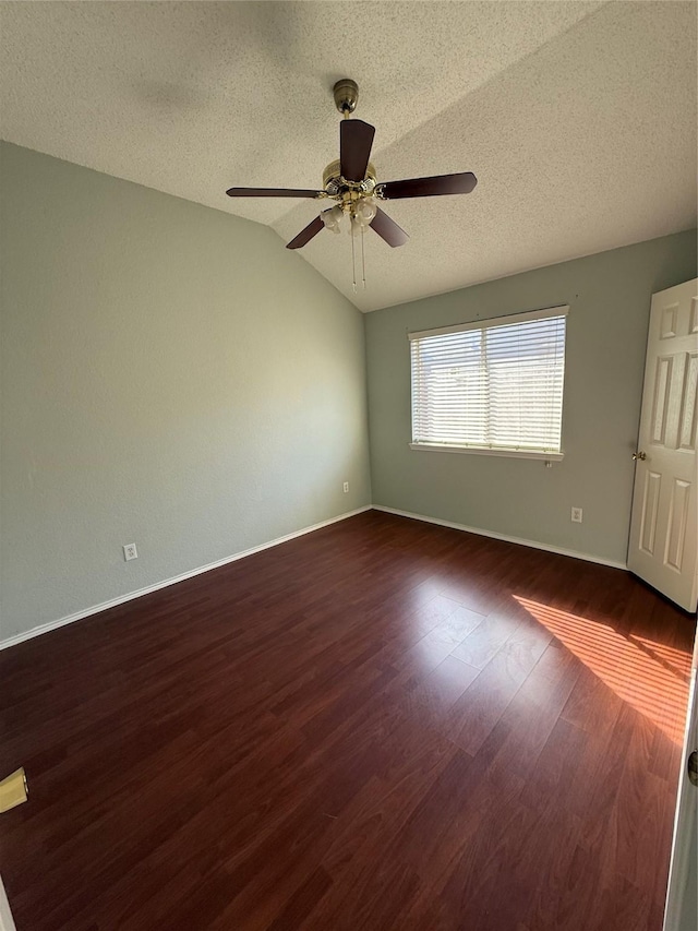 1401 Williams Crk, Mesquite, TX 75181 - unfurnished room with a textured ceiling, ceiling fan, vaulted ceiling, and dark wood-style flooring