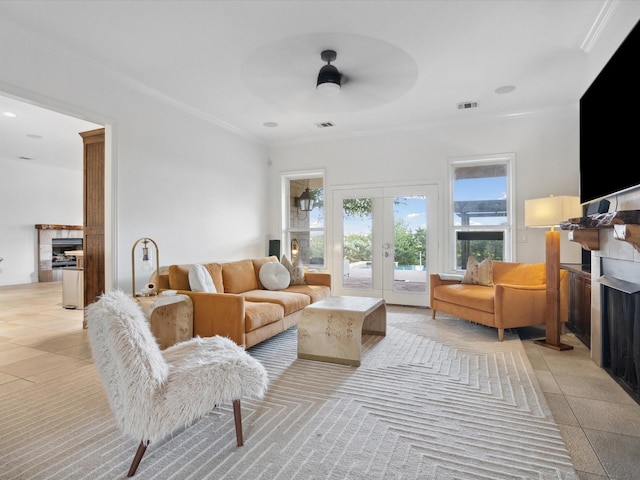 186 Deer Creek Dr, Aledo, TX 76008 - living room featuring a tiled fireplace, a ceiling fan, crown molding, and french doors