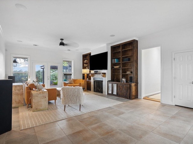 186 Deer Creek Dr, Aledo, TX 76008 - living area with a fireplace, french doors, ceiling fan, and light tile patterned floors