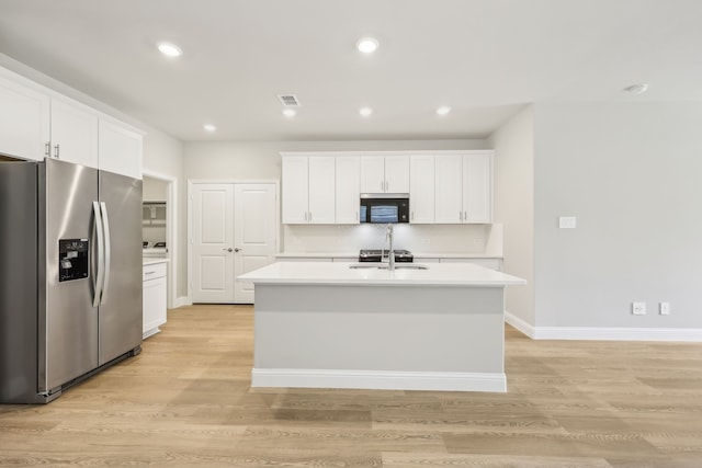 505 Willet Dr, Mckinney, TX 75069 - kitchen with stainless steel fridge, light countertops, an island with sink, white cabinets, and backsplash