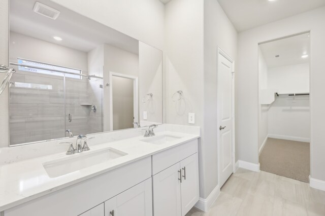 505 Willet Dr, Mckinney, TX 75069 - bathroom with double vanity, a stall shower, a walk in closet, and recessed lighting